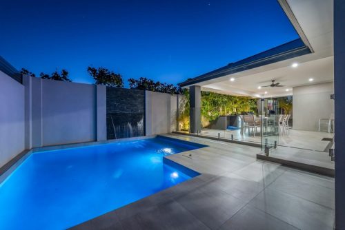 Back yard of a property with a pool.