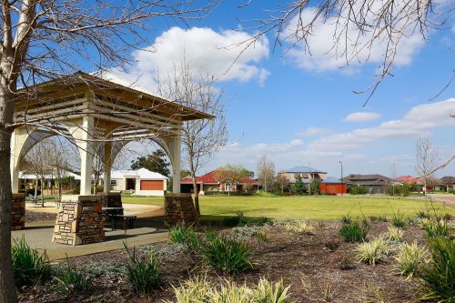 Park with a veranda and seating area.