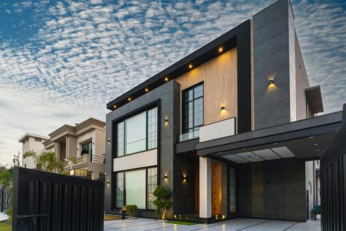 Stylish newly constructed home with a landscaped front yard, illustrating the debate: is it cheaper to build or buy?